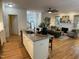 Open-concept living space with kitchen island, fireplace, and abundant natural light, perfect for entertaining at 409 Parkside Cir, Chapel Hill, NC 27516