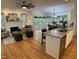 Open living space with fireplace, hardwood floors, and large windows, connecting to the dining and kitchen areas at 409 Parkside Cir, Chapel Hill, NC 27516