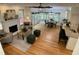 An airy living space featuring hardwood floors, a fireplace, and a combined dining and kitchen area at 409 Parkside Cir, Chapel Hill, NC 27516