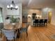 Open-concept living space features a dining area, kitchen with bar seating, and hardwood floors at 409 Parkside Cir, Chapel Hill, NC 27516