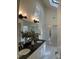 Main bathroom features dual sinks, black granite countertops, tiled floors and a glass shower at 409 Parkside Cir, Chapel Hill, NC 27516