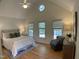 Bright main bedroom with vaulted ceilings, multiple windows, hardwood floors, and a sitting area at 409 Parkside Cir, Chapel Hill, NC 27516