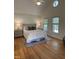Bright and open main bedroom features a large bed and vaulted ceilings with windows at 409 Parkside Cir, Chapel Hill, NC 27516