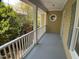 Inviting covered porch with white railings and a unique circular window detail at 409 Parkside Cir, Chapel Hill, NC 27516