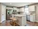 Bright kitchen with white cabinetry, stainless steel appliances, and a center island with barstool seating at 42 Saintsbury Dr, Fuquay Varina, NC 27526