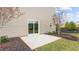 Outdoor patio with sliding door access, freshly mulched garden beds, and a level yard at 487 Lochalsh Dr, Gibsonville, NC 27249
