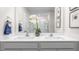 Bright bathroom with double vanity, quartz countertops, decorative flower arrangement, and framed art at 487 Lochalsh Dr, Gibsonville, NC 27249