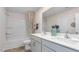 Bathroom featuring double vanity, bathtub and shower with wood-look vinyl flooring at 487 Lochalsh Dr, Gibsonville, NC 27249