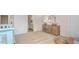 Bedroom features wooden dresser with a mirror, complemented by plush carpet and neutral wall paint at 487 Lochalsh Dr, Gibsonville, NC 27249