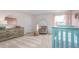 Bedroom with rainbow wall art, grey rocking chair, side table, and a teal-colored crib by a window at 487 Lochalsh Dr, Gibsonville, NC 27249