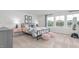Bedroom with large windows, iron bed with pink accents, and plush ottomans at 487 Lochalsh Dr, Gibsonville, NC 27249