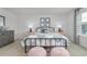 Charming bedroom with a metal bed frame, carpet flooring, and an abundance of natural light at 487 Lochalsh Dr, Gibsonville, NC 27249