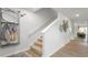 Well-lit entryway featuring neutral walls, modern decor, and a staircase with carpeted steps and white railings at 487 Lochalsh Dr, Gibsonville, NC 27249
