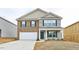 Two-story home featuring brick and vinyl siding, a manicured lawn, and an attached two-car garage at 487 Lochalsh Dr, Gibsonville, NC 27249