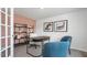 Bright home office featuring soft peach accent wall, neutral carpet and two blue chairs at 487 Lochalsh Dr, Gibsonville, NC 27249