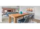 Open concept kitchen with grey countertops, a wood table with barstool seating, blue vase and view of living room at 487 Lochalsh Dr, Gibsonville, NC 27249