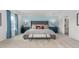 Elegantly furnished main bedroom with a king-size bed, accent wall, and matching nightstands with lamps at 487 Lochalsh Dr, Gibsonville, NC 27249