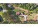 Estate aerial view showing well maintained grounds, mature trees, a home, and a separate garage at 50 Gill Ln, Fuquay Varina, NC 27526