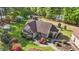 Aerial view of home featuring mature landscaping, inviting porch, detached garage and access to the lake at 50 Gill Ln, Fuquay Varina, NC 27526