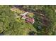 Estate home surrounded by trees and colorful foliage, with a separate garage, and deck overlooking the backyard at 50 Gill Ln, Fuquay Varina, NC 27526