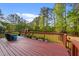 Inviting back deck with a wood railing overlooking a private wooded backyard at 50 Gill Ln, Fuquay Varina, NC 27526