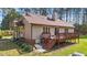 Charming backyard view with a wooden deck, a quaint garden, and pathway, offering a tranquil outdoor experience at 50 Gill Ln, Fuquay Varina, NC 27526