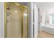 Bathroom showcasing a shower with gold trim and a view of the vanity and soaking tub at 50 Gill Ln, Fuquay Varina, NC 27526