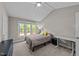 Bedroom featuring a window with natural light, a full-sized bed, a desk, and neutral decor at 50 Gill Ln, Fuquay Varina, NC 27526