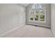 Bright bedroom with plush carpet, large windows, and vaulted ceiling at 50 Gill Ln, Fuquay Varina, NC 27526
