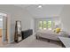 Bright bedroom featuring a large window, neutral paint, and a dresser at 50 Gill Ln, Fuquay Varina, NC 27526