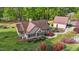 Beautifully landscaped home featuring a detached garage, vibrant flowerbeds, and a cozy front porch at 50 Gill Ln, Fuquay Varina, NC 27526