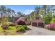 Beautiful home with a detached two-car garage, vibrant landscaping, and a private setting among mature trees at 50 Gill Ln, Fuquay Varina, NC 27526