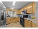 Well-lit kitchen featuring wooden cabinets, granite countertops, and stainless steel appliances at 50 Gill Ln, Fuquay Varina, NC 27526