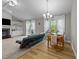 Open-concept living room and dining area featuring built-in shelving, wood floors and plenty of natural light at 50 Gill Ln, Fuquay Varina, NC 27526