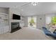 Spacious living room featuring a fireplace, built-in shelves, and sliding glass doors leading to the deck at 50 Gill Ln, Fuquay Varina, NC 27526