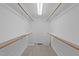 Walk-in closet with a single light and shelving on both sides at 50 Gill Ln, Fuquay Varina, NC 27526