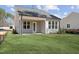 Charming backyard view with a covered patio, lush green lawn, and the home's exterior at 512 Gainer Dr # 4, Raleigh, NC 27610