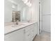 Elegant bathroom featuring double vanity sinks, quartz countertops, and a glass enclosed shower at 512 Gainer Dr # 4, Raleigh, NC 27610