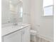 Bright bathroom featuring a white vanity, toilet, and shower with modern fixtures and ample natural light at 512 Gainer Dr # 4, Raleigh, NC 27610