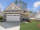 Charming home featuring stone accents, a two-car garage, and a well-manicured front yard at 512 Gainer Dr # 4, Raleigh, NC 27610