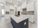 Bright, modern kitchen with white cabinets, stainless steel appliances, and a dark blue center island at 512 Gainer Dr # 4, Raleigh, NC 27610