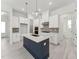 Bright, modern kitchen with white cabinets, stainless steel appliances, and a dark blue center island at 512 Gainer Dr # 4, Raleigh, NC 27610