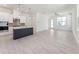 Open-concept living room and kitchen with hardwood floors, white walls, and abundant natural light at 512 Gainer Dr # 4, Raleigh, NC 27610