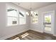 Inviting dining room with modern chandelier, large windows, and access to the outdoor deck at 528 Folk Song Way, Wendell, NC 27591