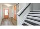 Bright foyer featuring a staircase, wood-look flooring, and a stylish peach-colored door at 528 Folk Song Way, Wendell, NC 27591