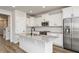 Modern kitchen boasts white cabinetry, stainless steel appliances, and a granite island at 528 Folk Song Way, Wendell, NC 27591