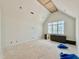 Bright attic room features a vaulted ceiling, a window, and gray cabinets at 5504 Kingwood Dr, Raleigh, NC 27609