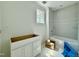 Bright bathroom features a tiled shower over tub and vanity at 5504 Kingwood Dr, Raleigh, NC 27609