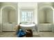 Bright bathroom with a soaking tub and cabinets at 5504 Kingwood Dr, Raleigh, NC 27609