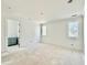 Bright bedroom featuring white walls, two windows, and access to another room at 5504 Kingwood Dr, Raleigh, NC 27609